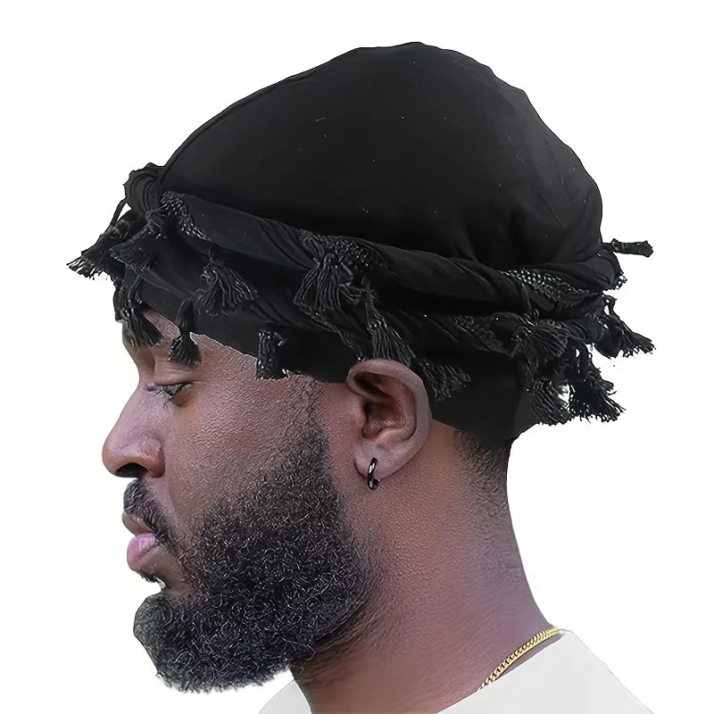 A man wearing a black vintage twist head wrap with tassels, shown in profile.