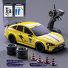 Yellow RC drift truck with racing and drifting tires and a charging cable