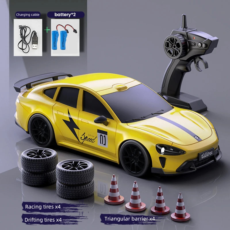 Yellow RC drift truck with racing and drifting tires and a charging cable