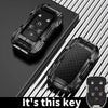A black zinc alloy key fob case for a Chevy Silverado or GMC Sierra truck is shown on a dark surface.