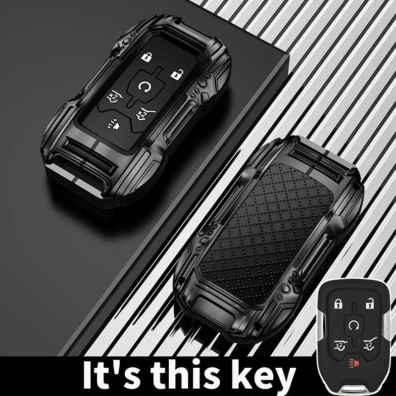 A black zinc alloy key fob case for a Chevy Silverado or GMC Sierra truck is shown on a dark surface.