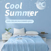 A light blue silk summer quilt is displayed on a bed, with ice cube graphics and cool temperature text in the background.