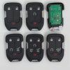 A set of replacement remote keys for Chevrolet and GMC vehicles, including black plastic remotes and a green electronic modul