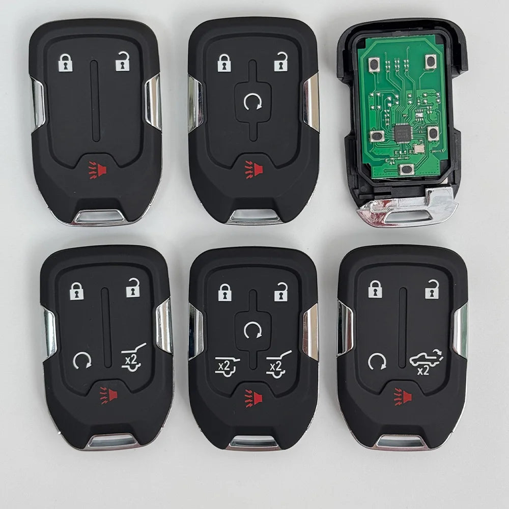 A set of replacement remote keys for Chevrolet and GMC vehicles, including black plastic remotes and a green electronic modul