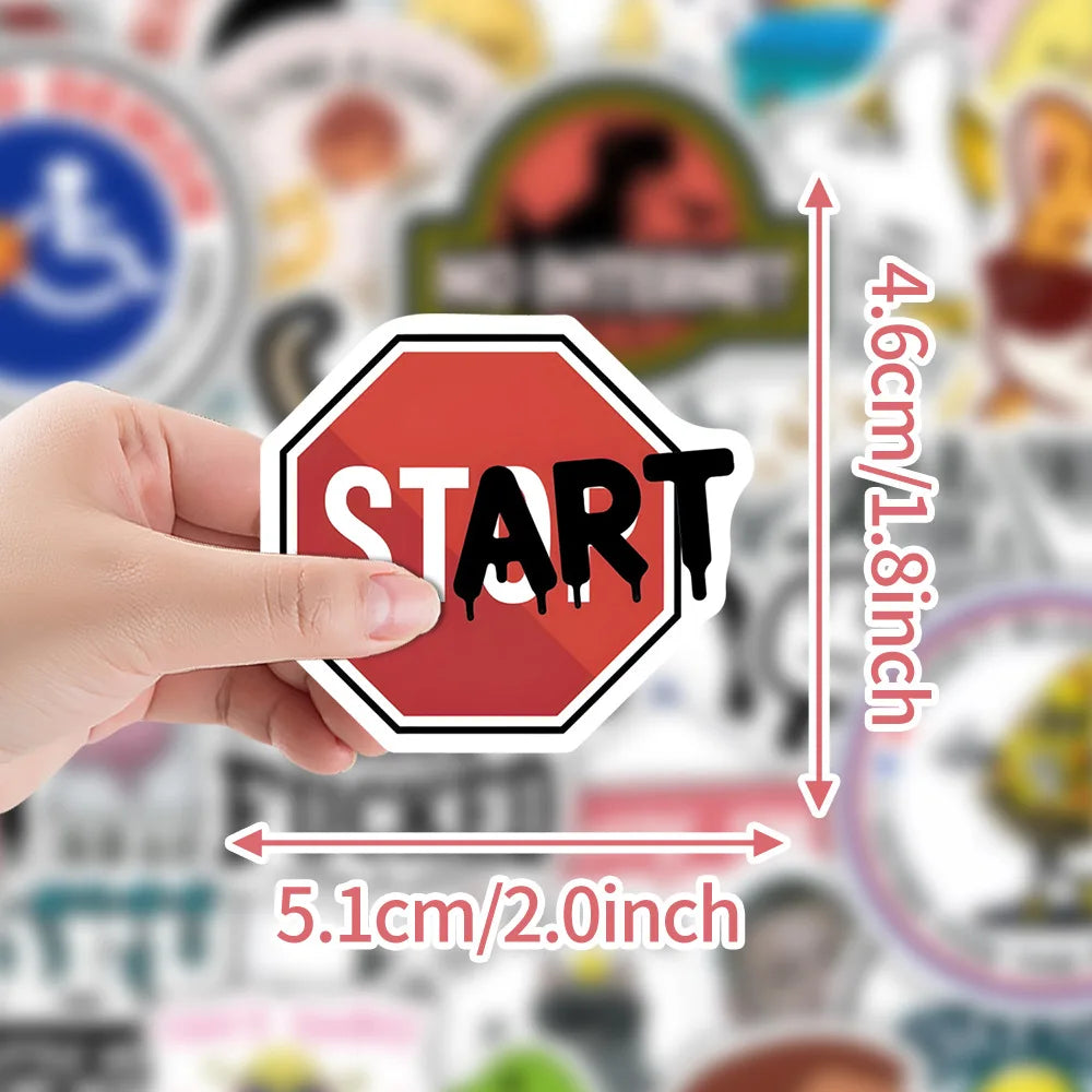 A hand holds a red hexagonal start sticker with the word START on it, showing its size.