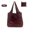 A black nylon reusable shopping tote bag with a pattern of pink or red hearts.