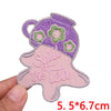 Purple and green floral embroidered patch shaped like a teapot with the text Spill the tea