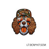 A brown embroidered hunting patch featuring a dog face wearing sunglasses and a hunter banner.