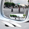 A wide-angle blind spot mirror mounted on a vehicle, showing the road and surrounding traffic.