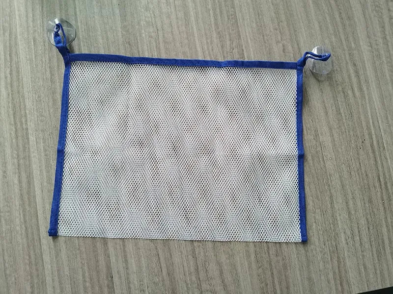 A square mesh silicone bath toy with blue trim and elastic loops for toddlers.