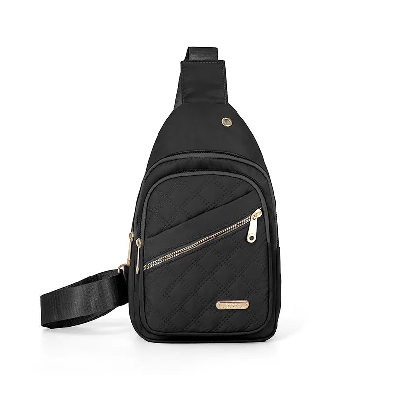Black quilted crossbody sling bag with a zippered front pocket and adjustable strap