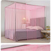 A pink lace canopy mosquito net draped over a bed with purple bedding and a bedside table.