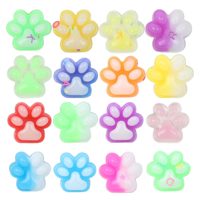 A collection of various squishy cat paw fidget toys in multiple colors including green yellow pink and blue.
