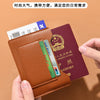 A brown leather passport holder is shown holding several identification cards and a passport.