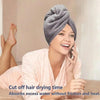 A woman is using a microfiber hair drying towel wrap while talking on a phone.