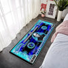 A rectangular blue and black banknote pattern anti-slip floor mat placed on a light gray floor next to a window.