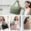 A woman is holding a green quilted puffy tote bag, demonstrating the fashion, lightweight, and comfort of the bag.