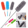 A set of four fuzzy electrostatic telescopic dusters in orange, blue, gray, and pink on stainless steel handles.