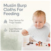 A baby is using a white muslin burp cloth for feeding, demonstrating easy cleanup and breathability.