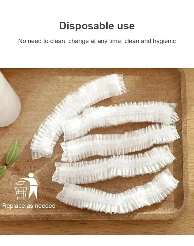 A wooden board shows several white disposable shower caps with elastic edges, emphasizing their single-use and hygienic natur