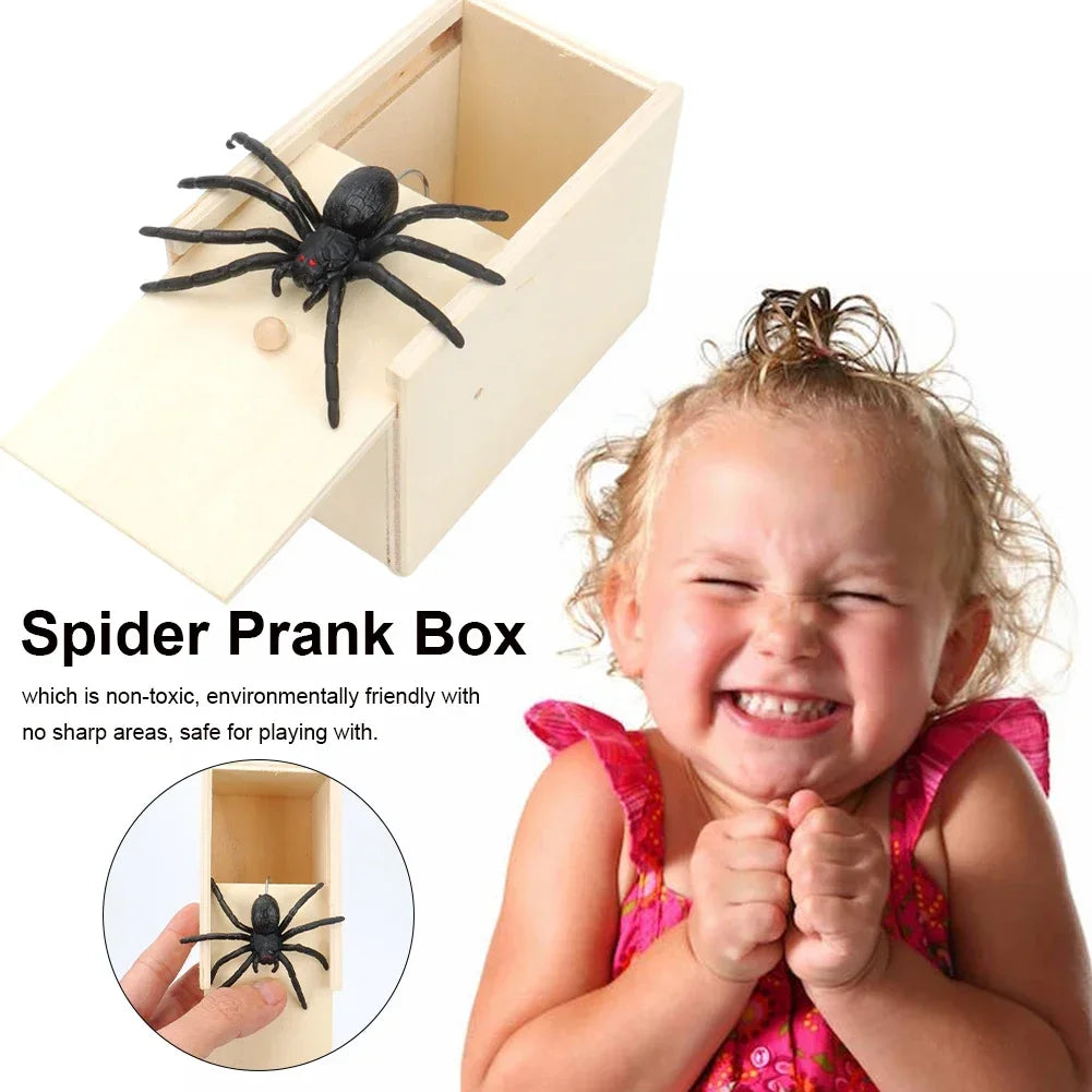 A young girl is holding a wooden spider prank box with a black spider inside.