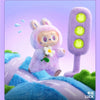 A fluffy purple Labubu plush doll with large ears and a white flower is shown next to a purple light switch.