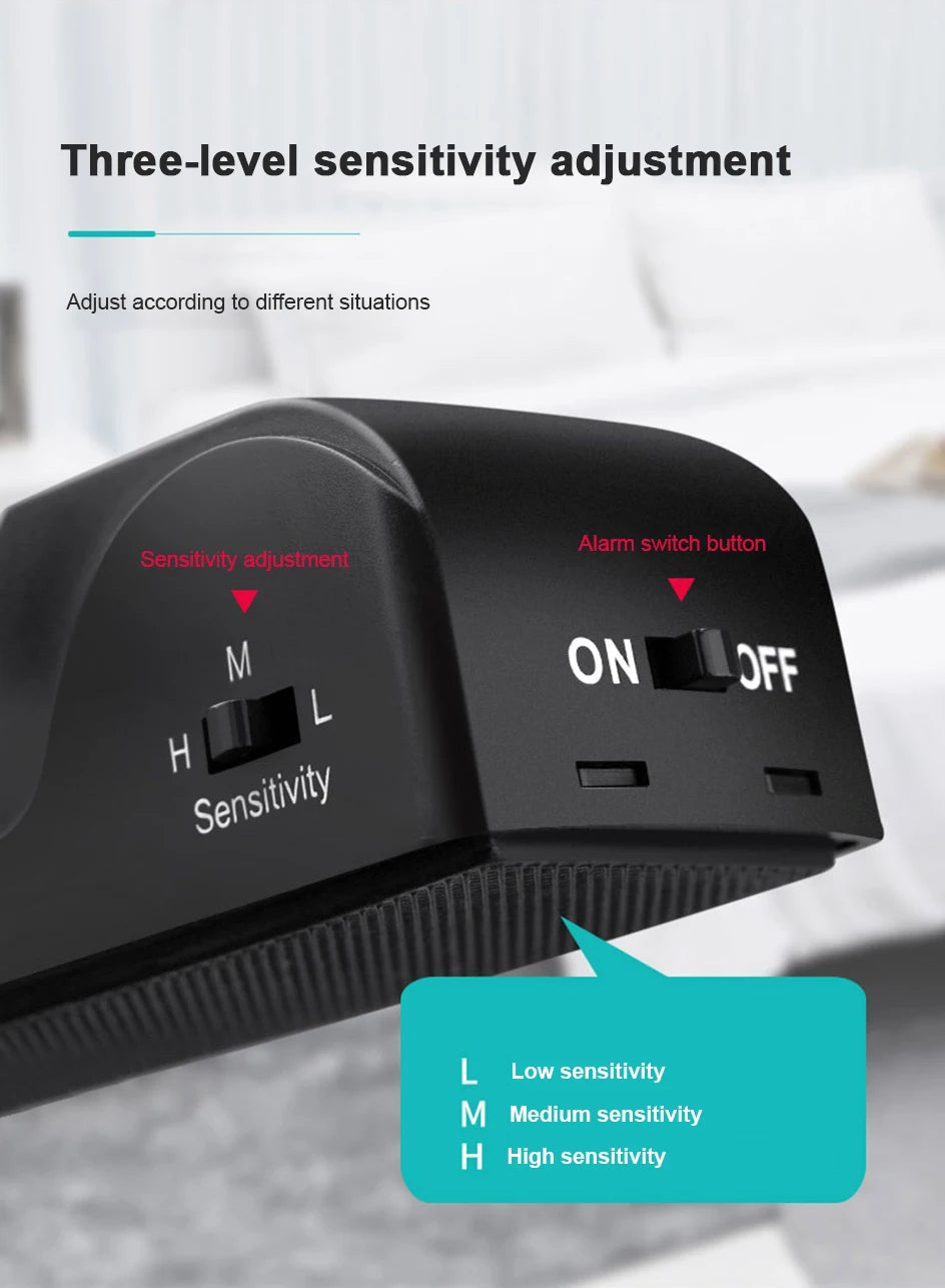 A black portable door stopper alarm device showing three sensitivity levels for adjustment.