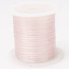 A roll of pink elastic cord for beading and jewelry making