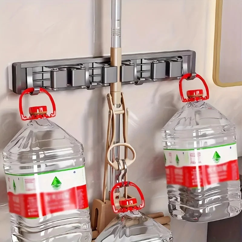 Wall-mounted metal mop and broom holder with detachable hooks for cleaning tools