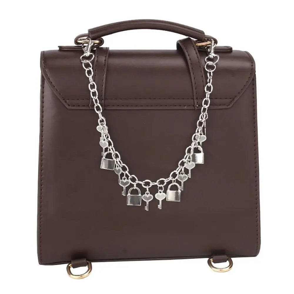 A dark brown leather handbag with a silver metal chain strap attached.
