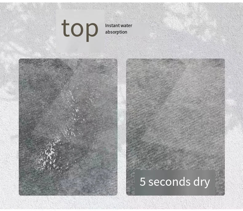 A close-up view of a dark gray rug demonstrating instant water absorption and drying in 5 seconds.