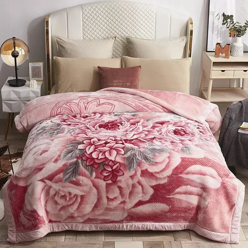 A pink weighted plush blanket featuring a floral pattern and reversible soft comfort.