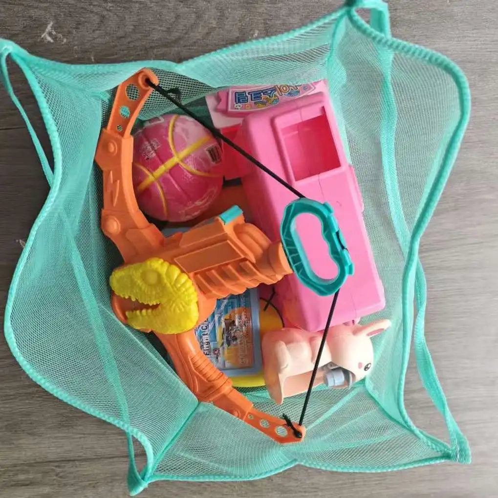 A pink plastic toy dinosaur and a bright orange plastic toy dinosaur are placed inside a teal mesh tote bag.
