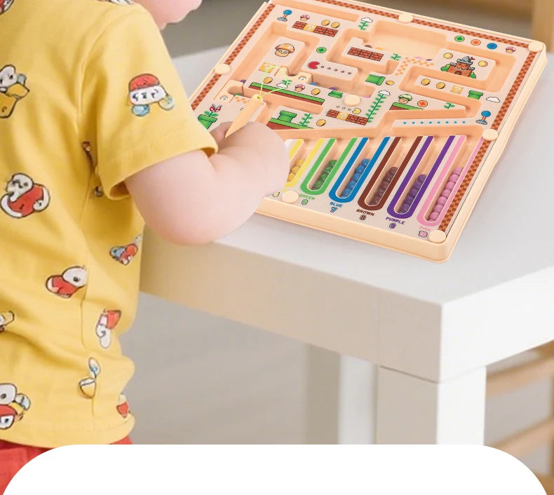 A child is using a magnetic maze logic puzzle board for early learning, featuring colorful wooden pieces and tracks.
