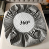 A gray quilted waterproof mattress protector with a deep pocket is displayed on a white surface.