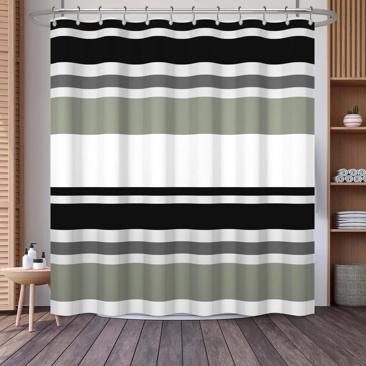 A shower curtain featuring horizontal geometric stripes in shades of black, gray, and olive green.
