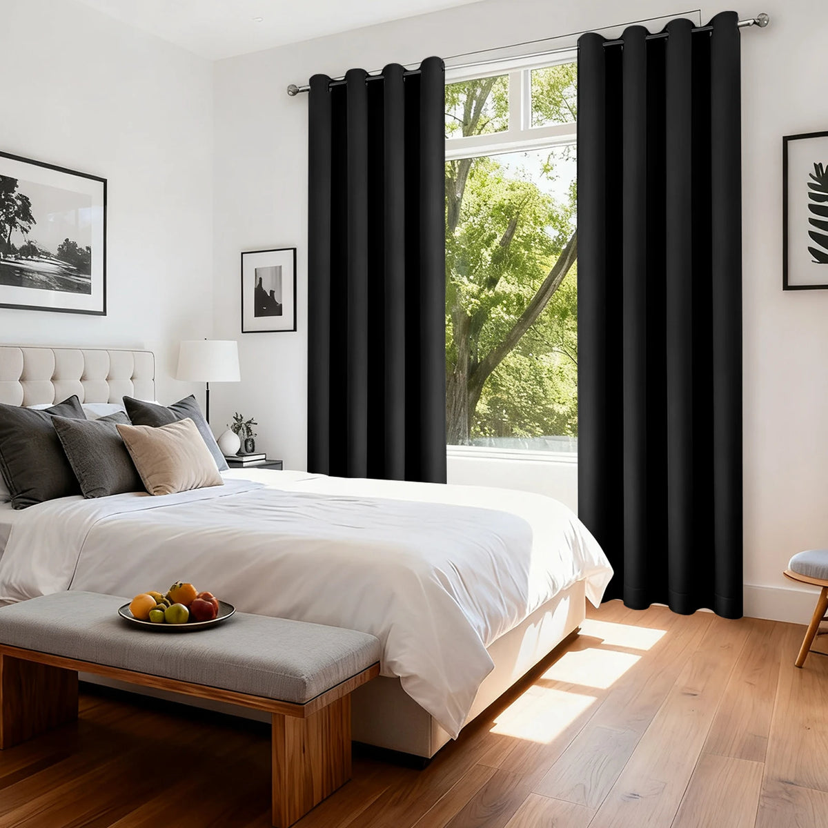 Blackout curtain panels with grommet top covering a window in a bright bedroom setting.