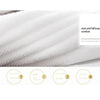 Close-up of a white soft cotton terry cloth face towel showing its texture and comfort features.