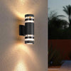 Modern black LED wall sconce with multiple light strips illuminating a textured wall outdoors