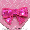 Pink sequin bow patches for DIY crafts set of five displayed on a pink cutting mat.
