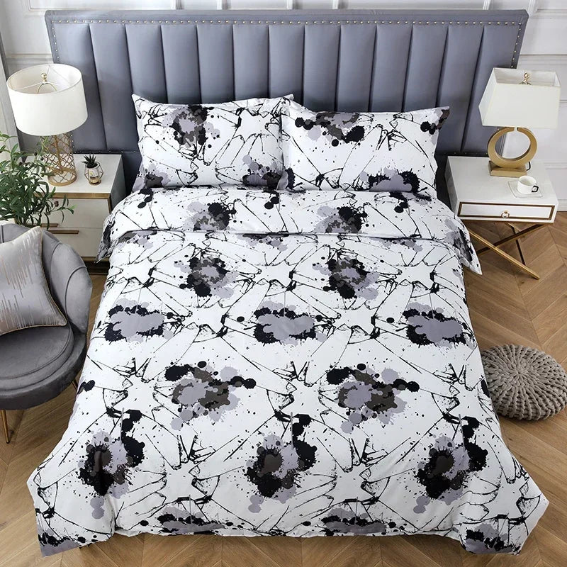A white duvet cover set with a black and gray abstract geometric pattern displayed on a bed.