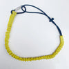 Sangle élastique jaune avec cordon et pince noire, utilisée pour vélos de montagne.