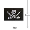 Black embroidered patch featuring a skull and crossed swords design with silver threads.