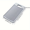 A white non-slip laundry scrubbing board with ribbed surface and handles.