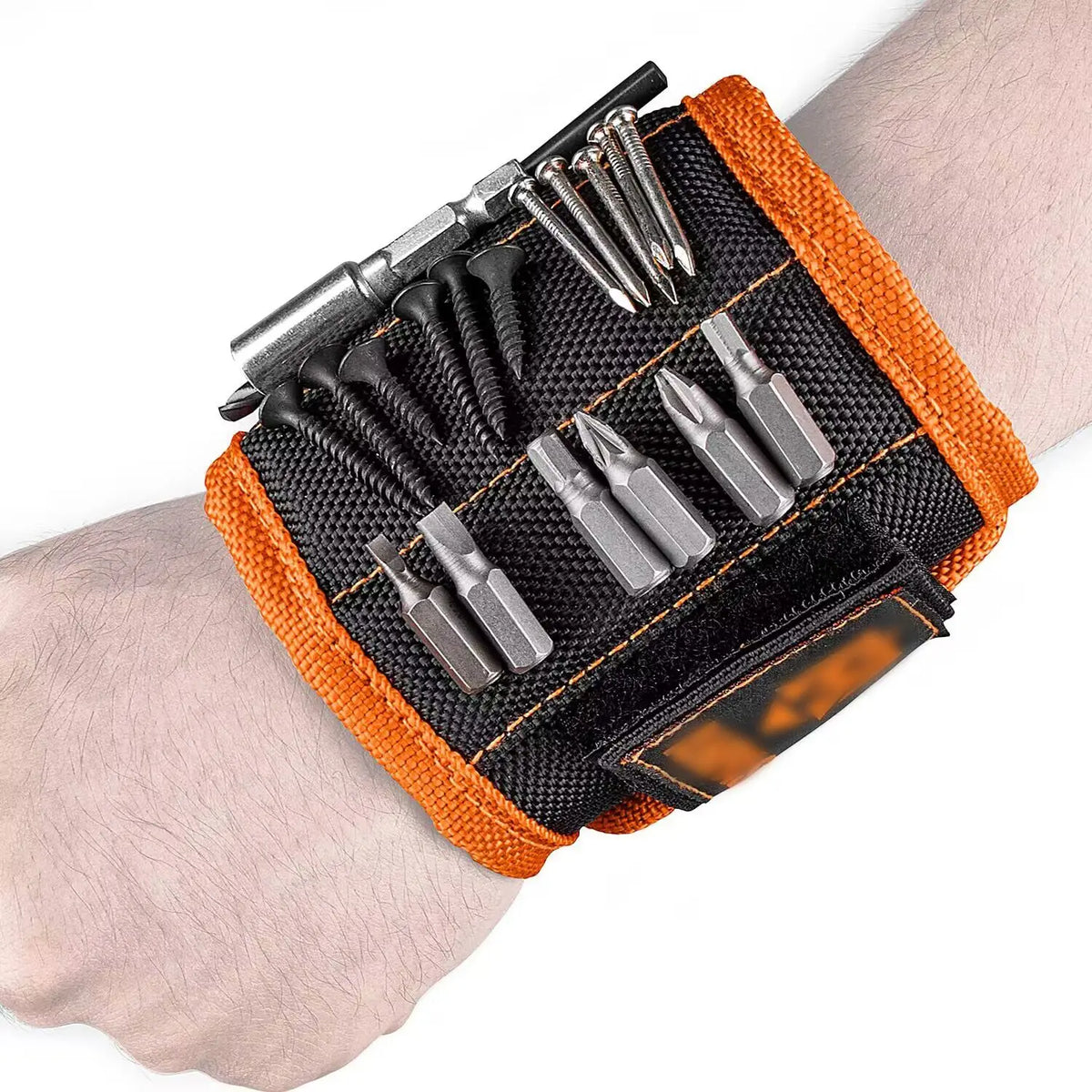 An orange magnetic wrist strap holding various screws, nails, and small tools.