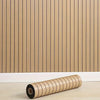 Roll of light wood-toned peel-and-stick wall panels installed on a vertical wooden slat background.