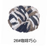 A ball of chunky acrylic yarn with a gray and white marbled pattern.