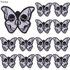 A set of ten black and gray embroidered iron-on patches featuring detailed skull and butterfly designs.