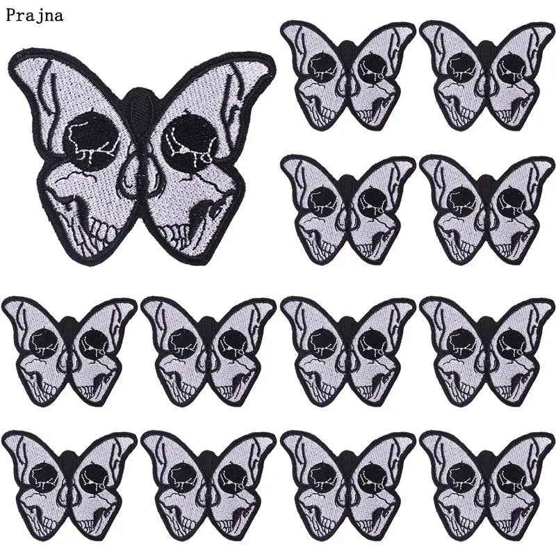 A set of ten black and gray embroidered iron-on patches featuring detailed skull and butterfly designs.