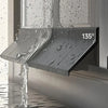 A close-up of a gray weatherproof sliding window seal strip dripping water onto a surface.